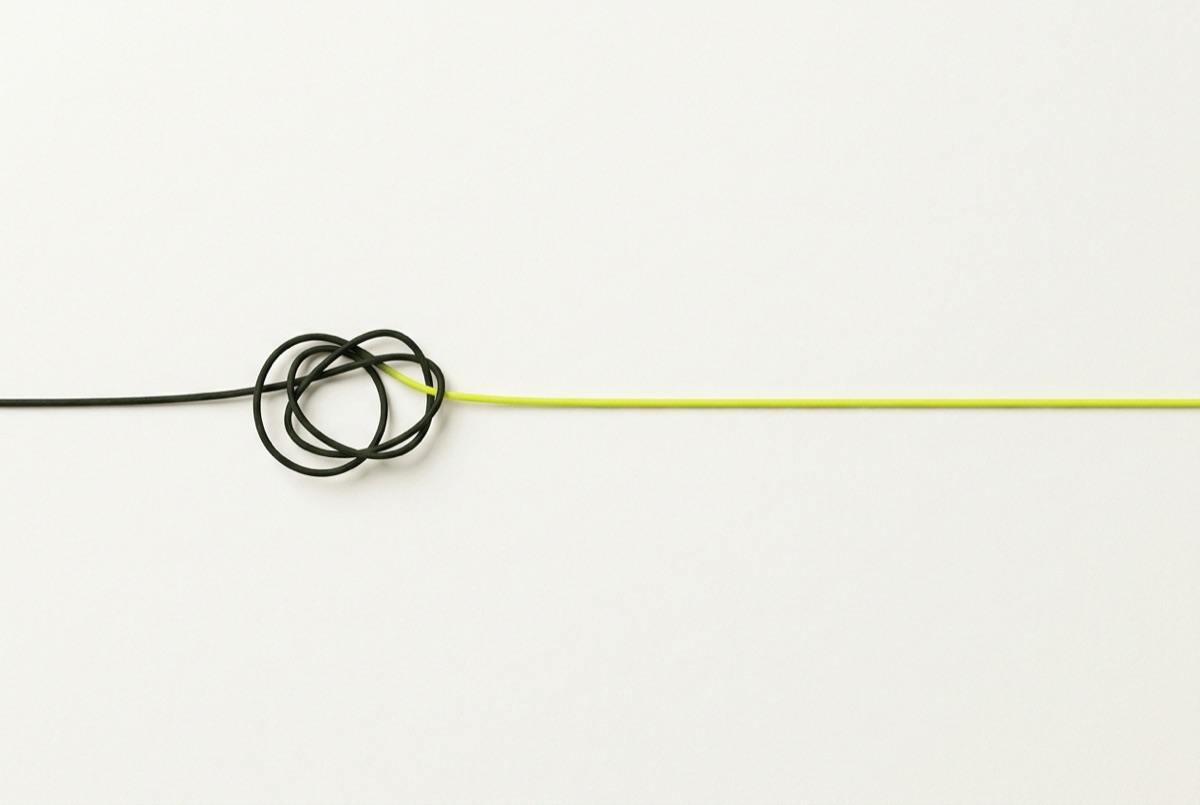 A thread with a small knot resolving into one straight yellow line